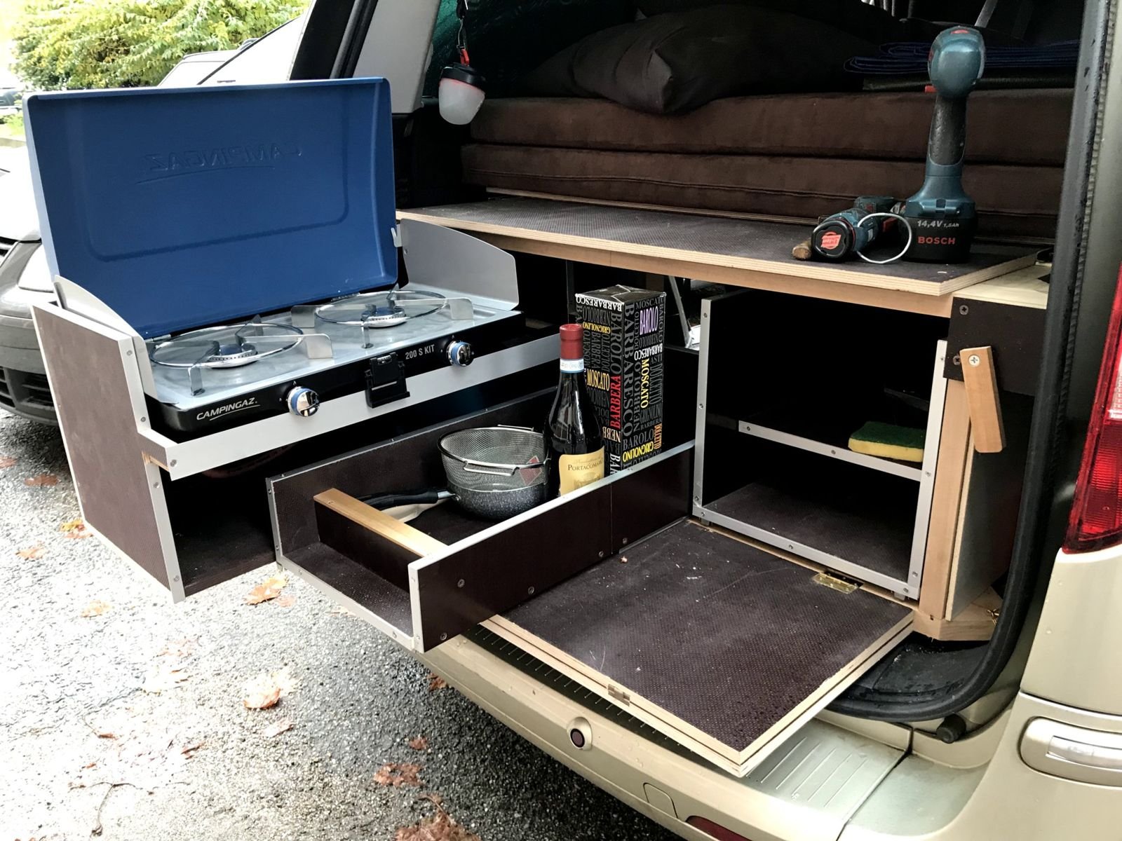 Auto trasformata in camper, con cucina estraibile e letto a due piazze